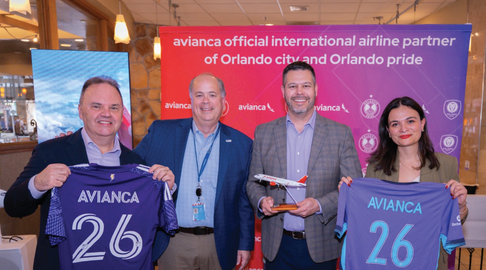 Avianca, Official International Airline Partner of Orlando City SC and Orlando Pride Avianca representatives with Orlando City SC and Orlando Pride jerseys