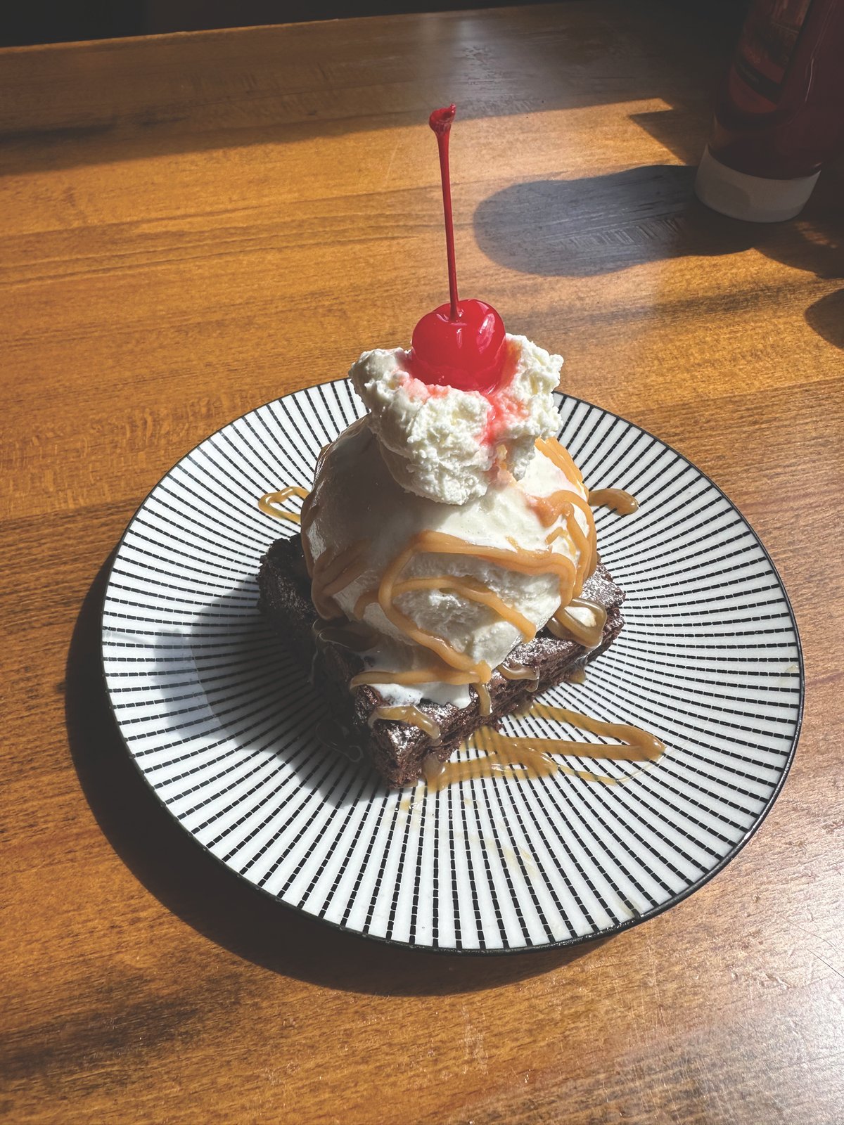 Palm Beach Meats Dessert Dessert topped with whipped cream, caramel and a cherry at Palm Beach Meats