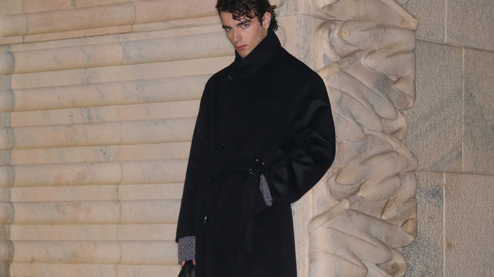 Giorgio Armani Fall/Winter 2026–27 menswear collection Model in a black belted double-breasted coat from the Giorgio Armani Fall/Winter 2026–27 menswear collection