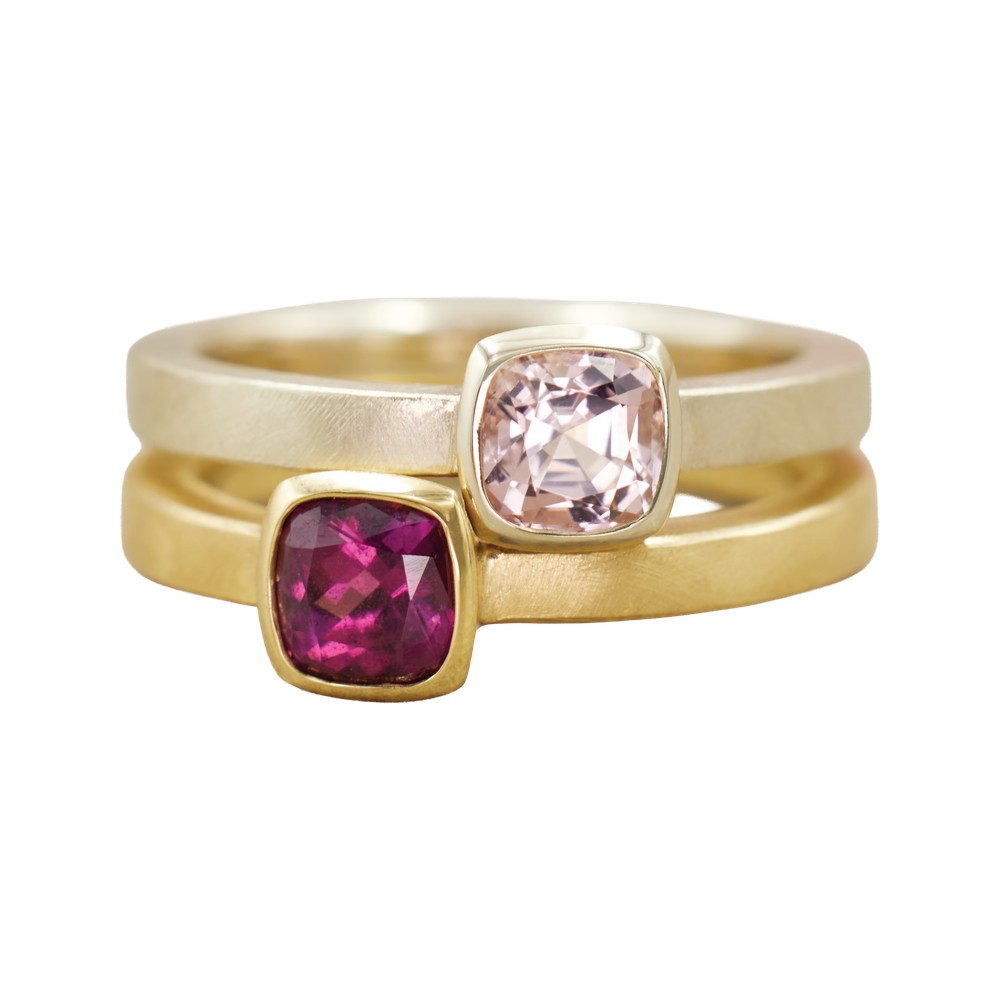 Almut Belote Blush Pink Tourmaline and Umbalite Garnet cushion rings stacked in two tones of gold