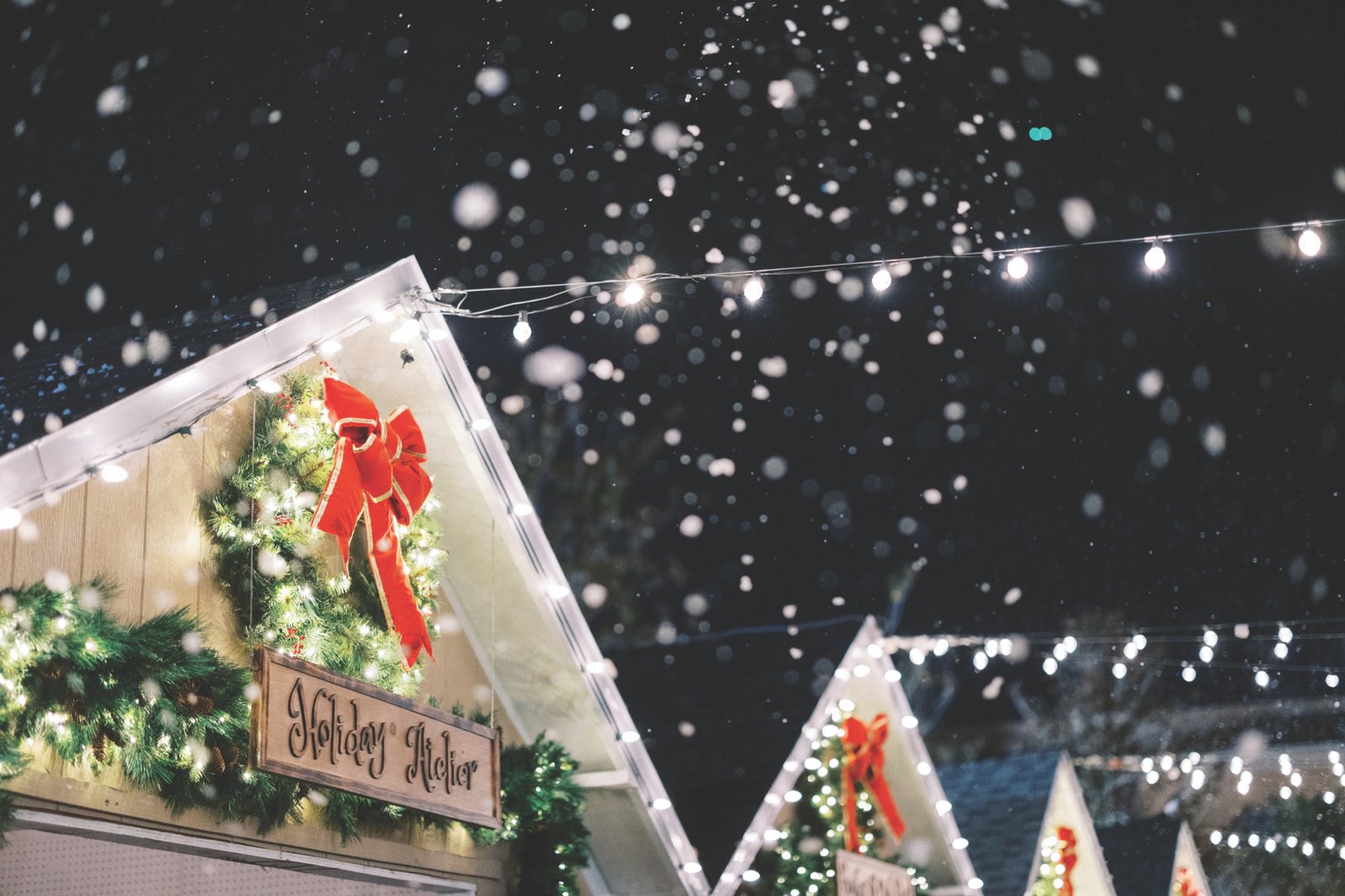 Grande Lakes Orlando Christmas Market Snowfall Snowfall over a decorated holiday cottage at the Grande Lakes Orlando Christmas Market