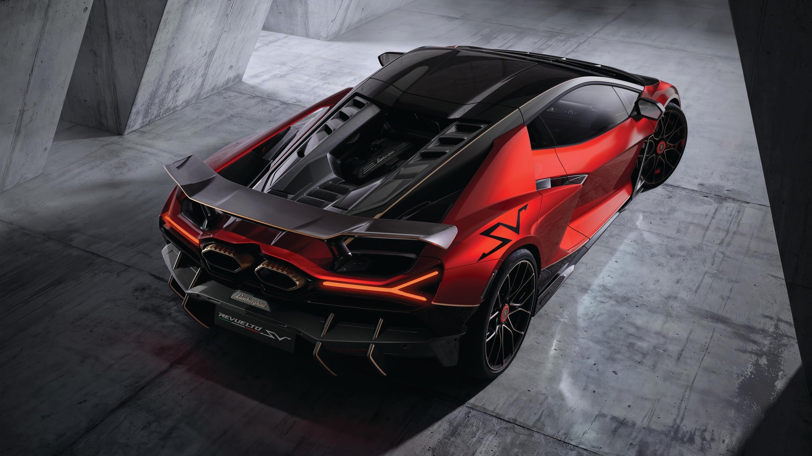 Lamborghini Revuelto SV rear view with fixed carbon wing Lamborghini Revuelto SV in red, seen from above at the rear with its fixed carbon-fiber wing