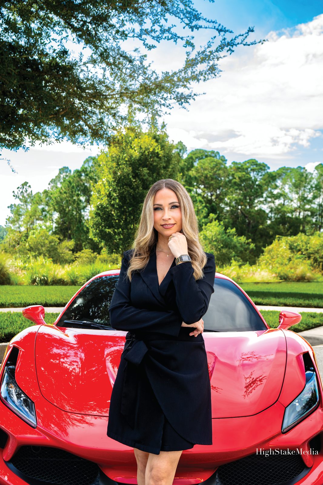 Sully Del Valle, Motor Volta Realtor Sully Del Valle of Jupiter Properties Group with a red sports car