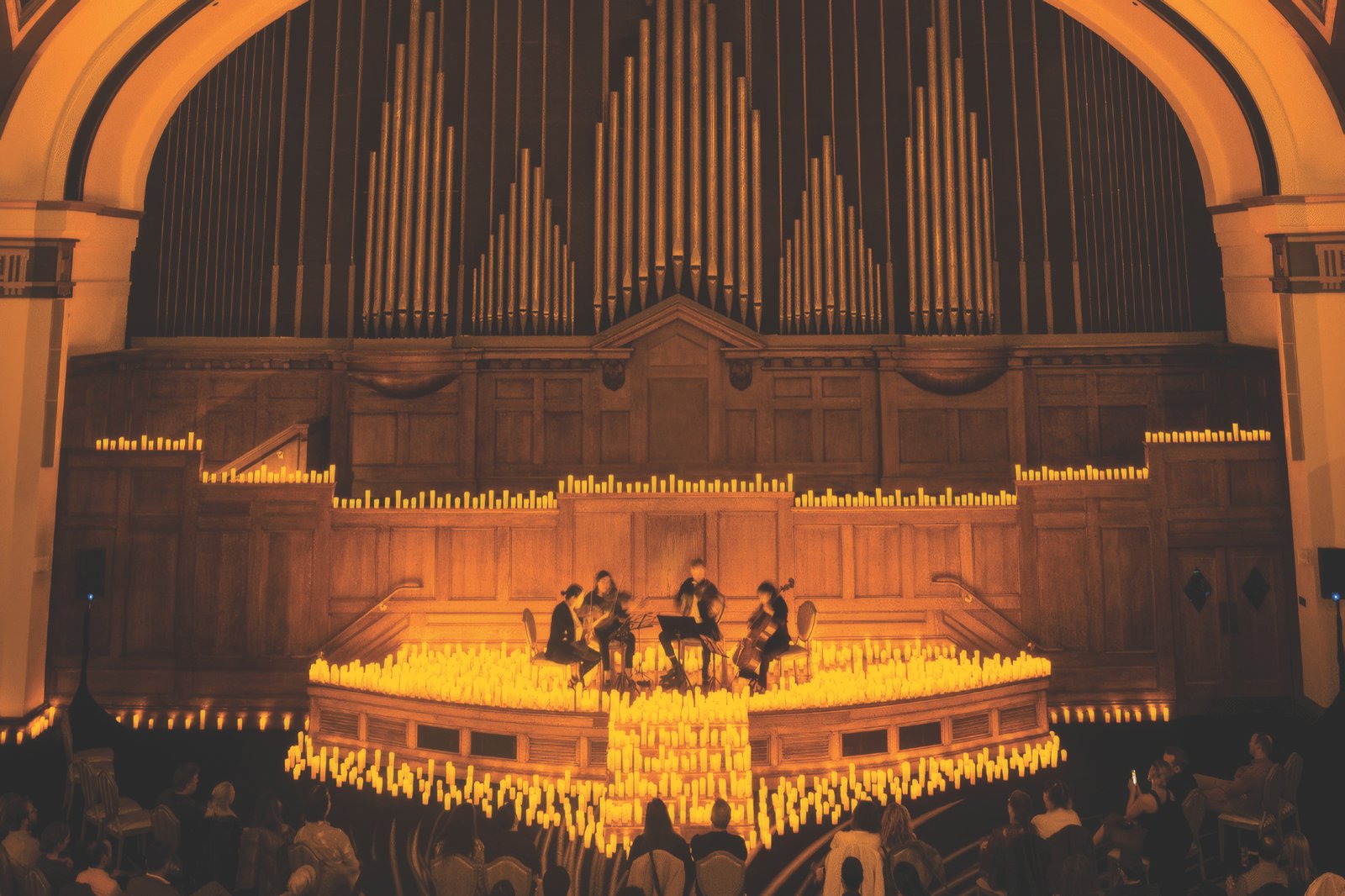 Candlelight Christmas Carols String quartet performing in a hall lit by hundreds of candles